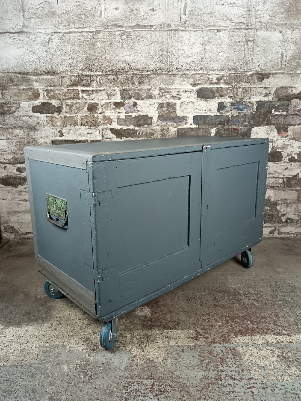 A slate grey painted 19th-century military campaign packing chest with iron flush handles, corner reinforcements, hinged doors, and an internal shelf. View V