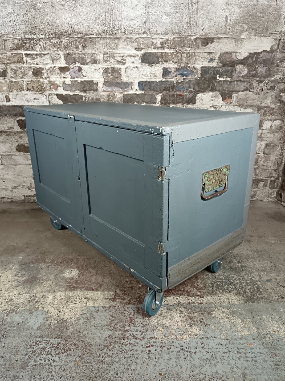 A slate grey painted 19th-century military campaign packing chest with iron flush handles, corner reinforcements, hinged doors, and an internal shelf. View VI