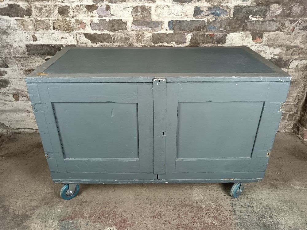 A slate grey painted 19th-century military campaign packing chest with iron flush handles, corner reinforcements, hinged doors, and an internal shelf. View IX