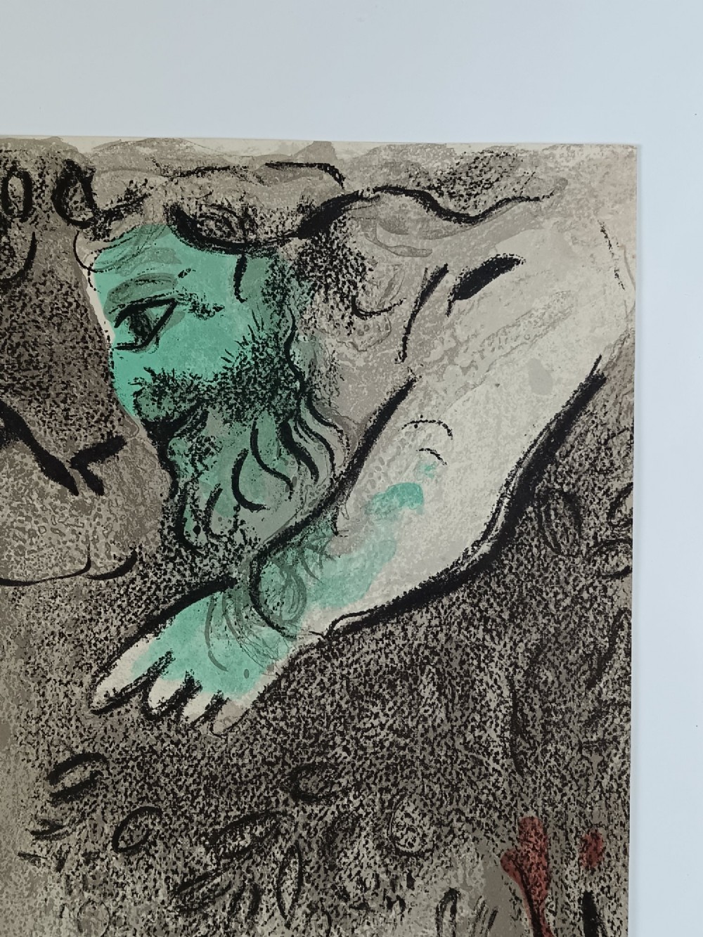 A 1960 double-sided colour lithograph on grey paper depicting a reclined terracotta figure beneath a green figurative motif and Hebrew lettering. View IV