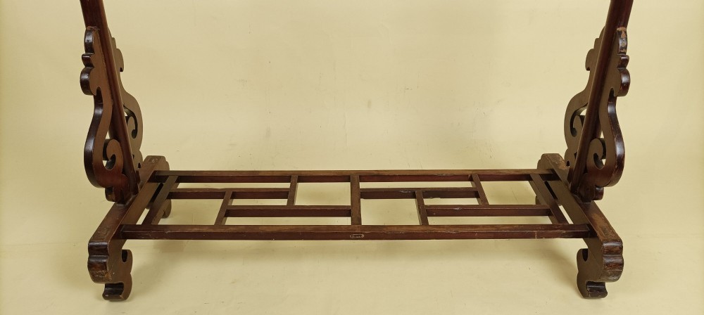 A late 19th-century Chinese red lacquered wooden robe stand with carved scroll terminals, horizontal crossbars, and a lower latticework base. View VI