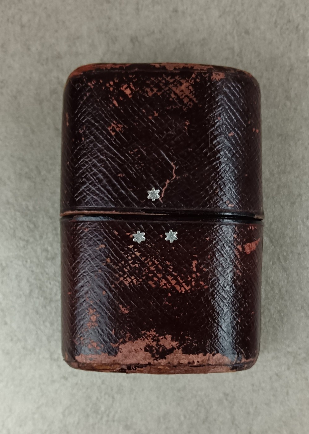 A Victorian folding campaign cutlery set featuring silver-plated utensils with light-coloured handles, a clear glass beaker, and a fitted dark red morocco leather carrying case. View II