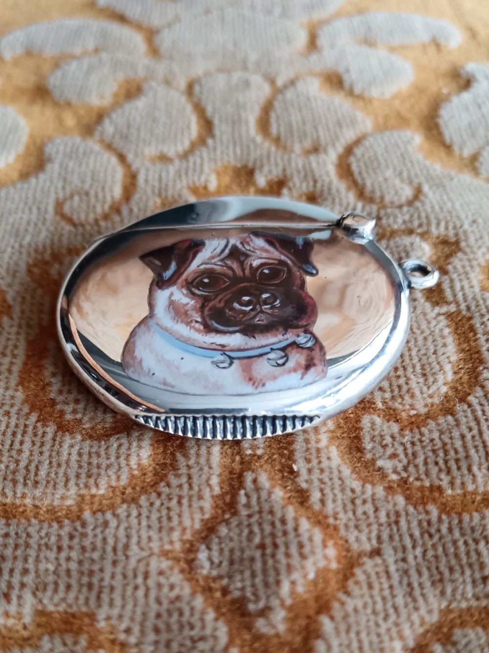 A rounded silver vesta case featuring a finely painted enamel portrait of a pug dog on the front face. View V