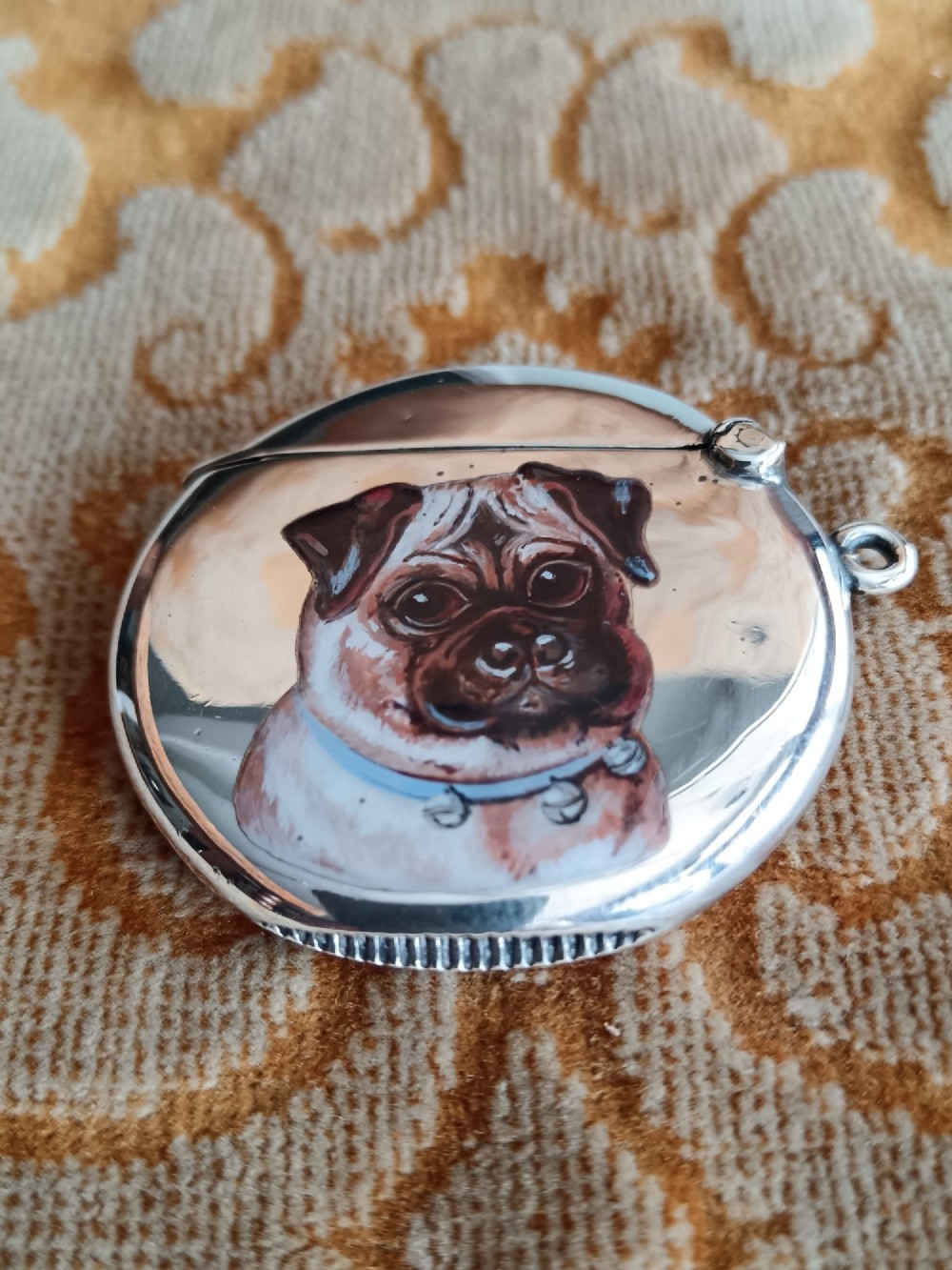 A rounded silver vesta case featuring a finely painted enamel portrait of a pug dog on the front face. View VI