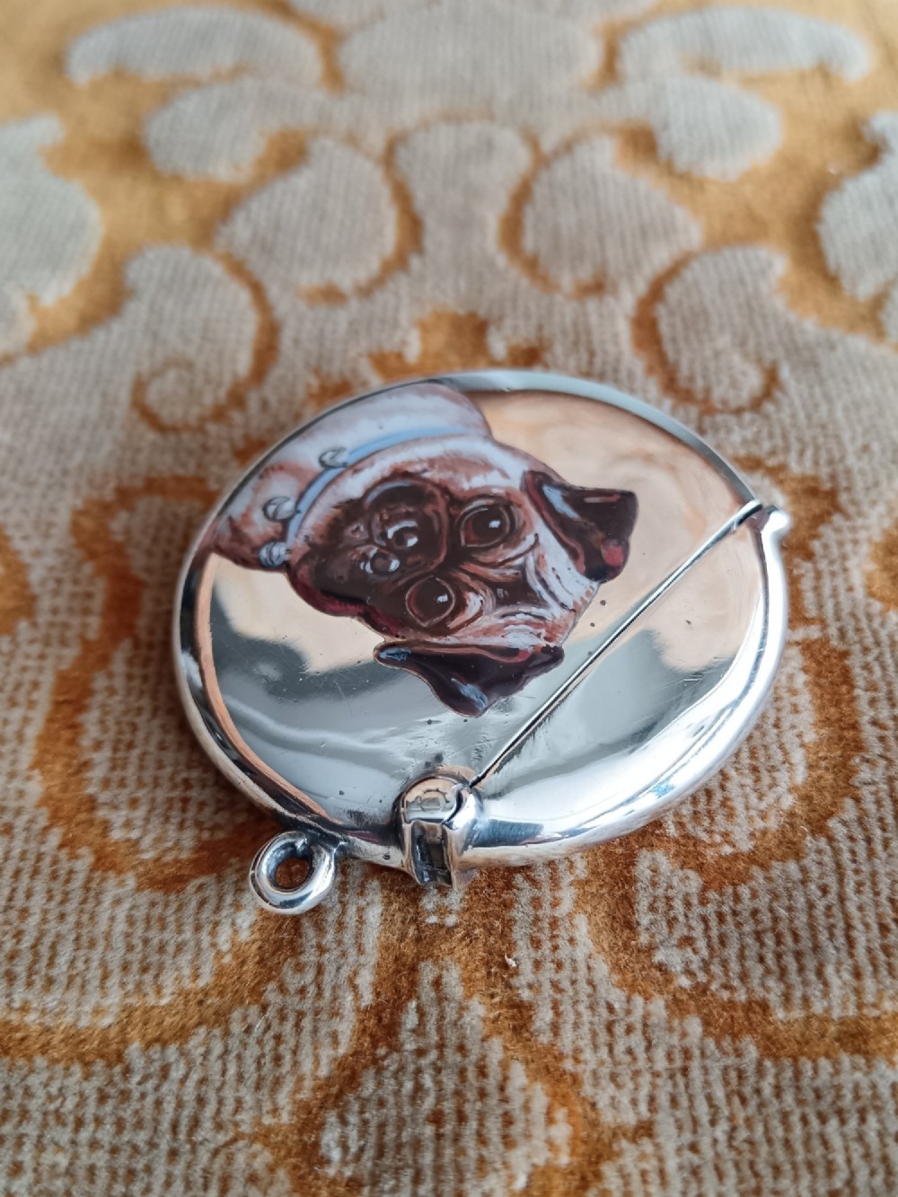 A rounded silver vesta case featuring a finely painted enamel portrait of a pug dog on the front face. View VII