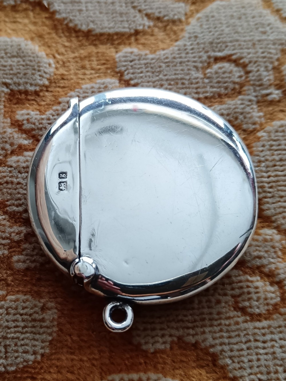 A rounded silver vesta case featuring a finely painted enamel portrait of a pug dog on the front face. View VIII