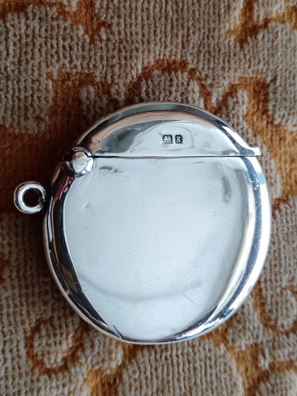 A rounded silver vesta case featuring a finely painted enamel portrait of a pug dog on the front face. View IX