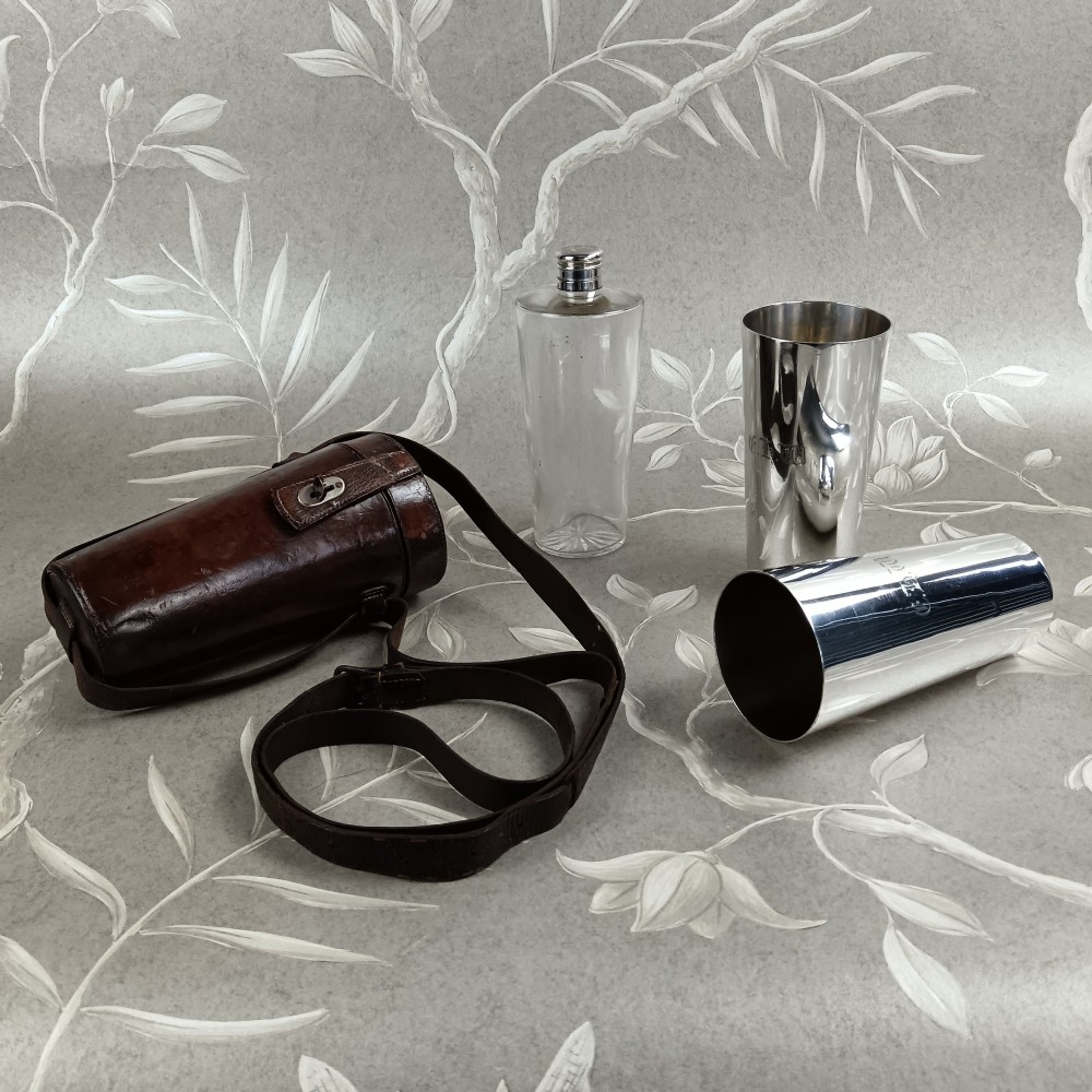 A Victorian leather campaign case with a shoulder strap alongside a glass flask and two silver-plated nesting beaker cups. View III