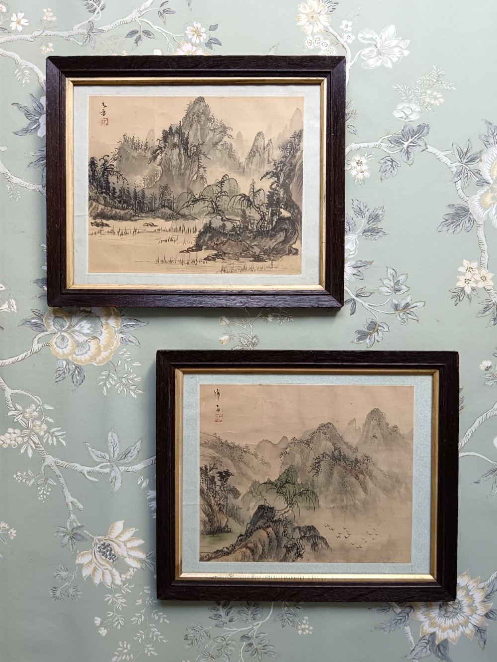 A pair of framed Chinese Shan Shui ink landscape paintings on silk depicting mountainous scenes and trees, presented in dark timber frames with gilded inner trims. View II