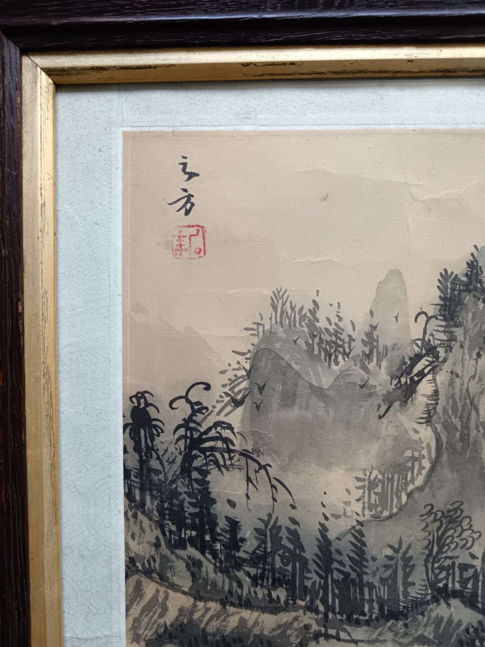 A pair of framed Chinese Shan Shui ink landscape paintings on silk depicting mountainous scenes and trees, presented in dark timber frames with gilded inner trims. View IV
