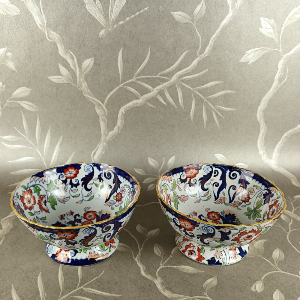 A pair of 19th-century Minton ironstone pedestal bowls with scalloped rims and vibrant Amherst Japan floral transfer pattern in cobalt blue, orange, and green. View IV