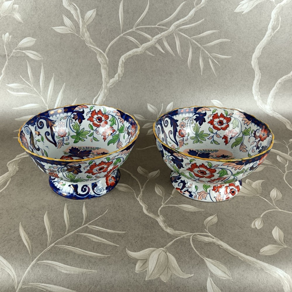 A pair of 19th-century Minton ironstone pedestal bowls with scalloped rims and vibrant Amherst Japan floral transfer pattern in cobalt blue, orange, and green. View VI