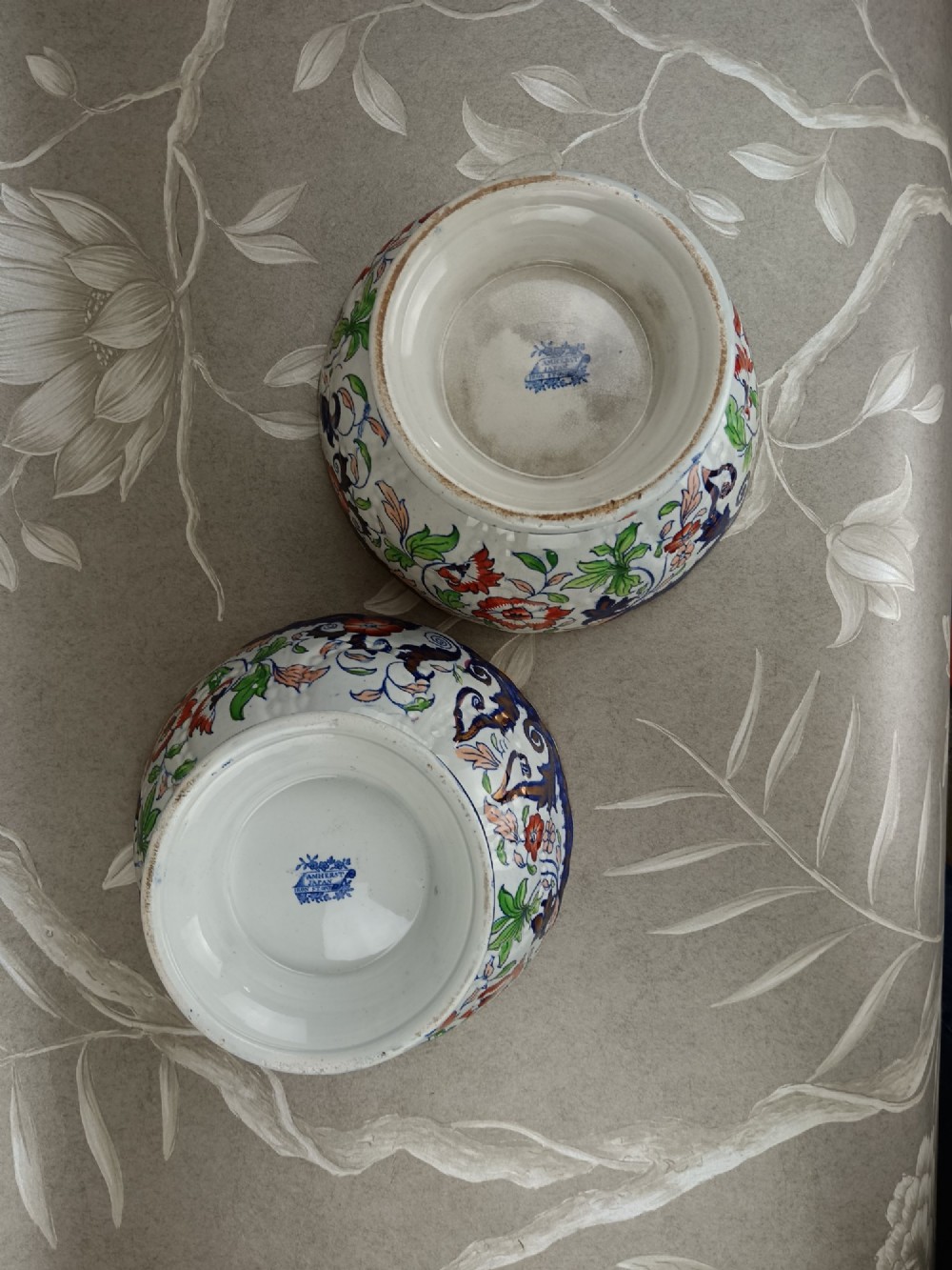 A pair of 19th-century Minton ironstone pedestal bowls with scalloped rims and vibrant Amherst Japan floral transfer pattern in cobalt blue, orange, and green. View IX