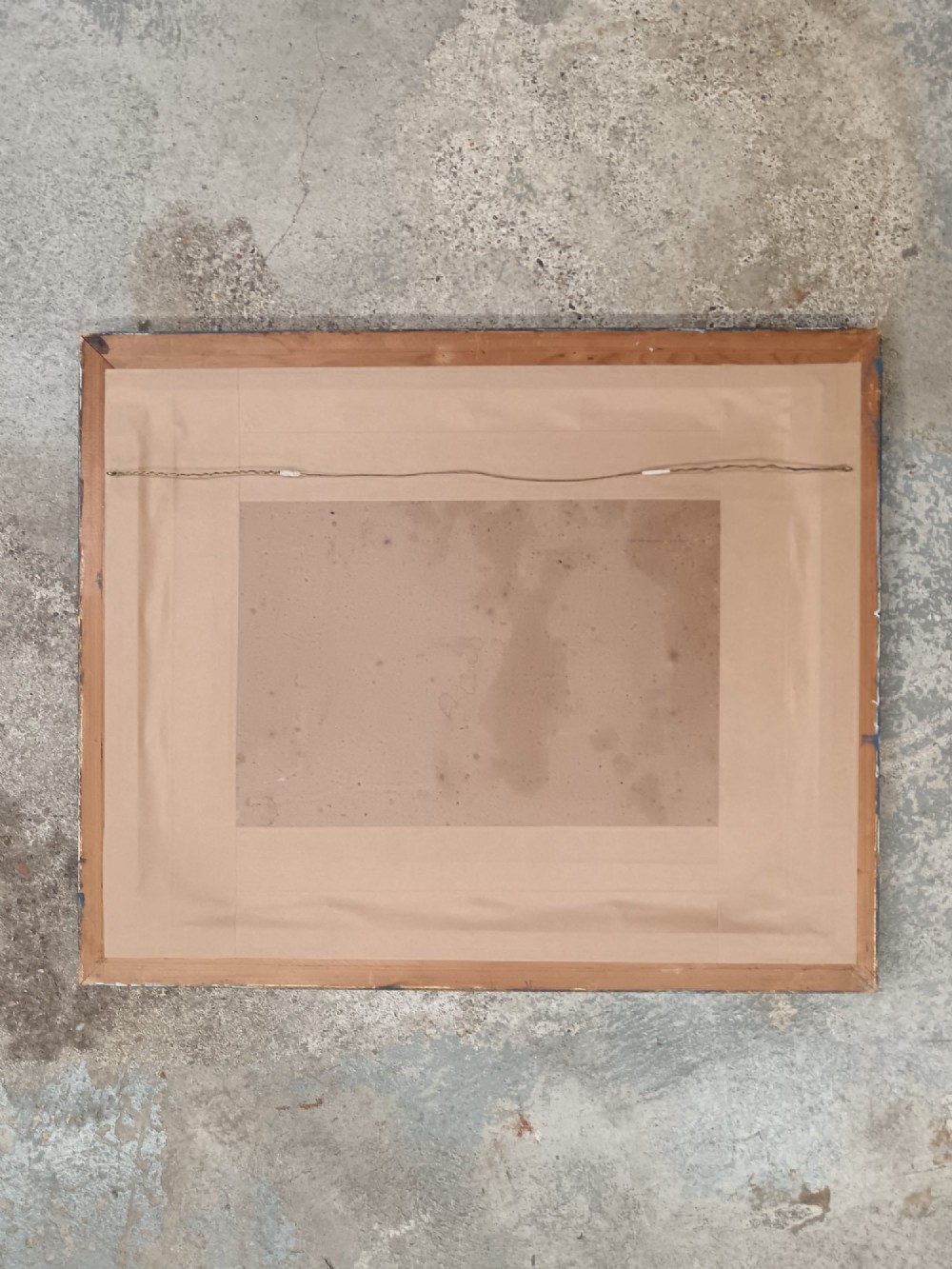 A mid-twentieth-century modernist oil painting on card depicting a bearded man in a green jacket seated in an artist studio, presented in a dark blue wooden frame. View IV