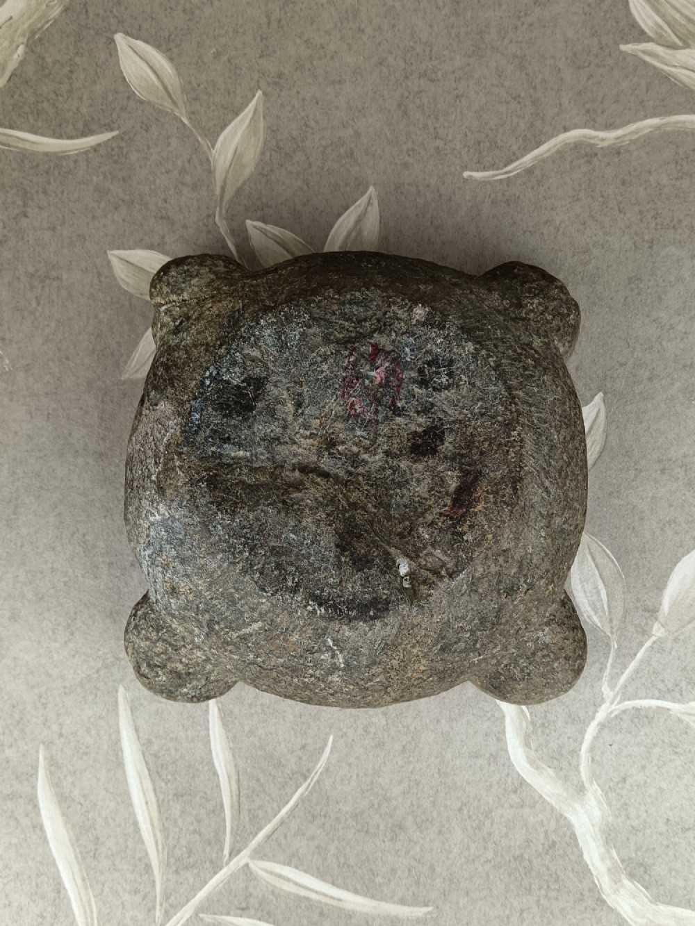 An antique hand-carved stone mortar featuring four corner lugs, shown with a turned fruitwood pestle. View XIII