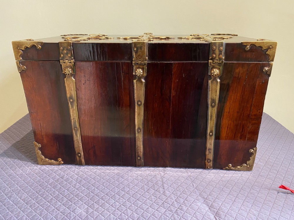 A dark kingwood rectangular cofre forte featuring elaborate brass strapwork, fleur-de-lis mounts, corner brackets, and a matching key in the foreground. View VI