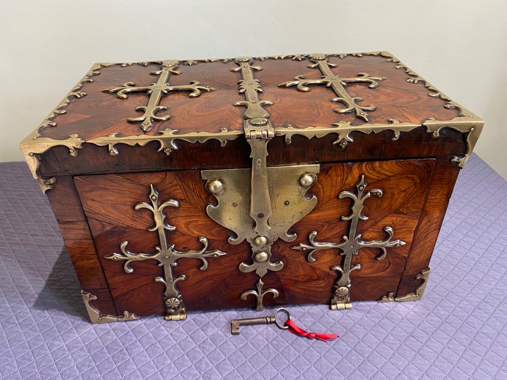 A rectangular late 17th-century William and Mary kingwood veneered coffre forte with pierced brass strapwork mounts and an accompanying brass key.