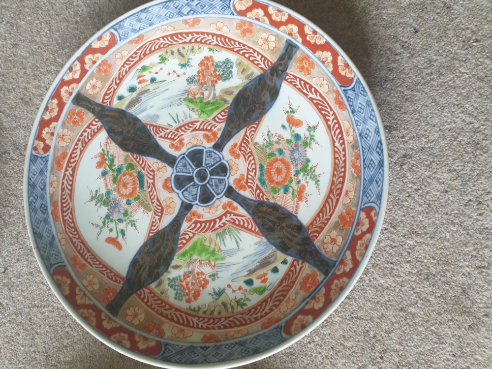 A set of four 19th-century Japanese Imari porcelain chargers decorated with intricate iron-red, cobalt blue, and gilded floral motifs. View II