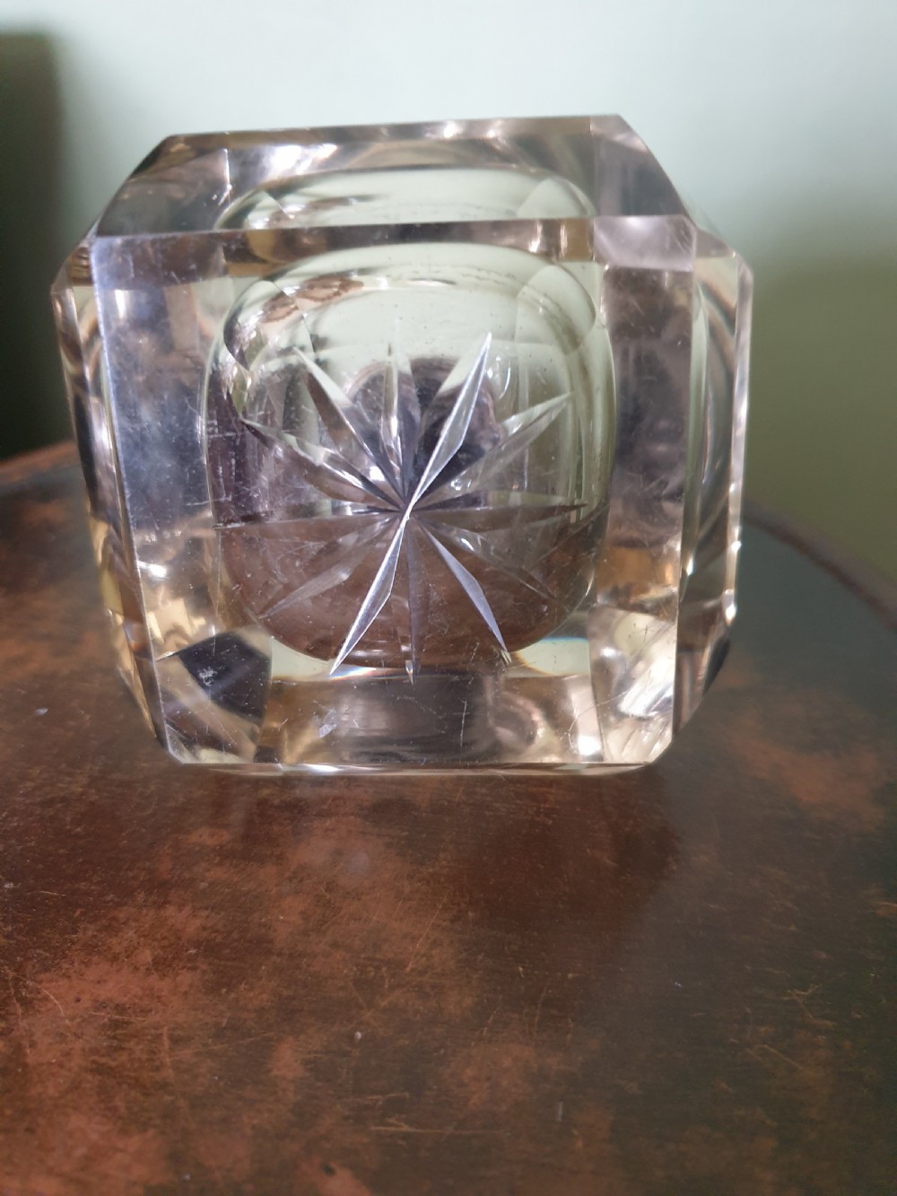 A heavy clear cut-glass inkwell featuring a starburst base design and a polished hinged silver lid with hallmarks. View III