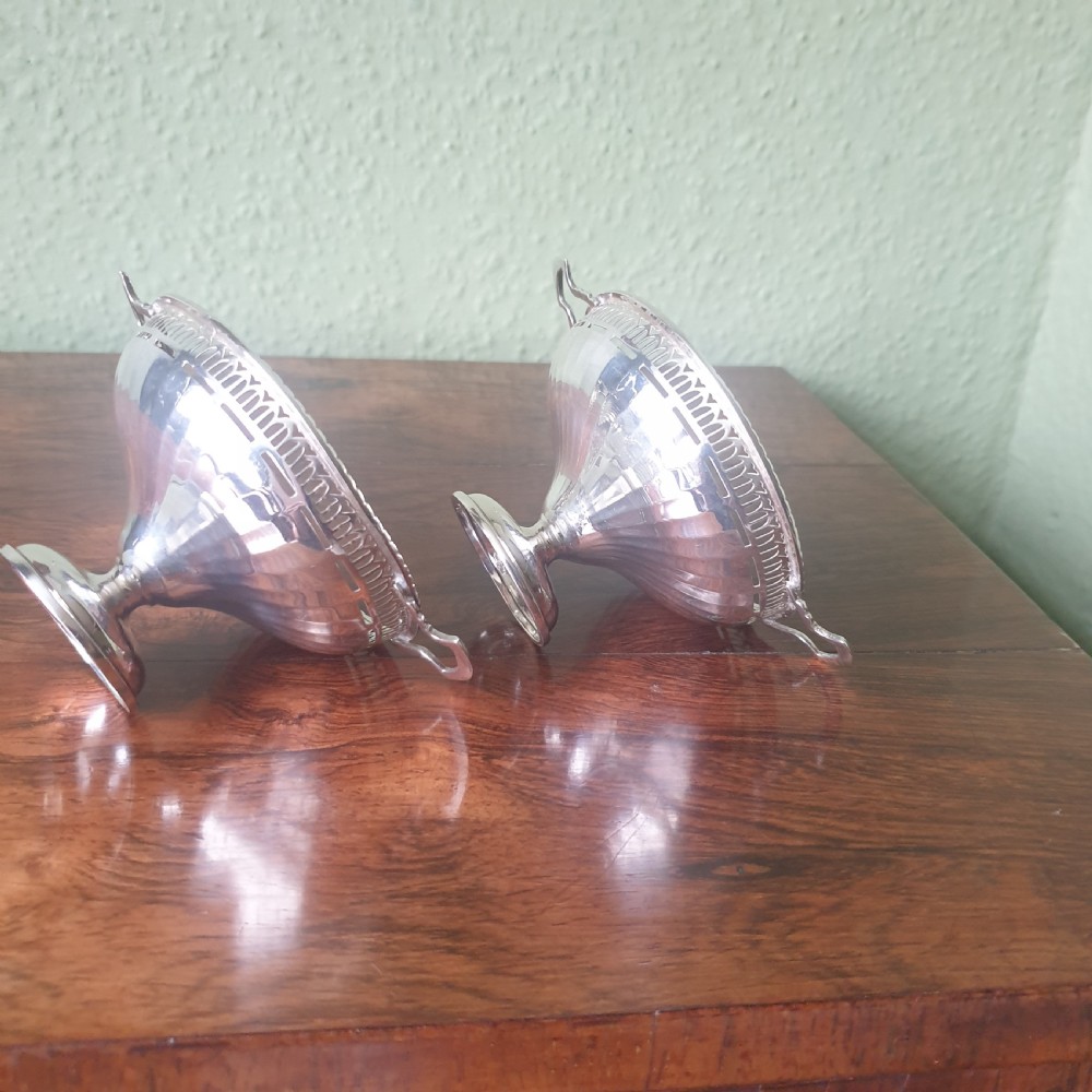 A pair of sterling silver tazzas featuring fluted bowls, pierced geometric rims, twin handles, and circular pedestal feet. View IV