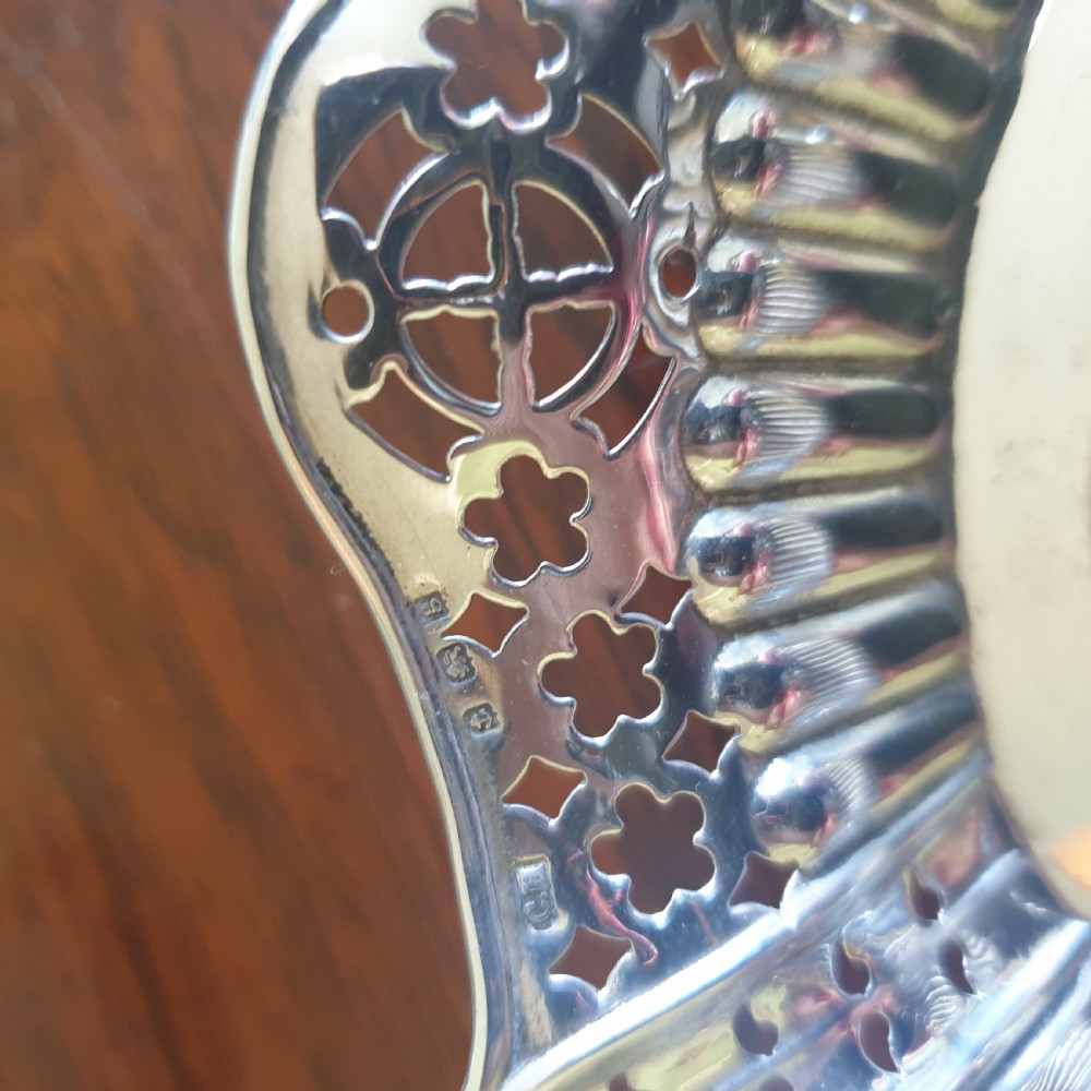 An Edwardian silver dish featuring pierced fretwork motifs along the rim and a fluted central well. View III