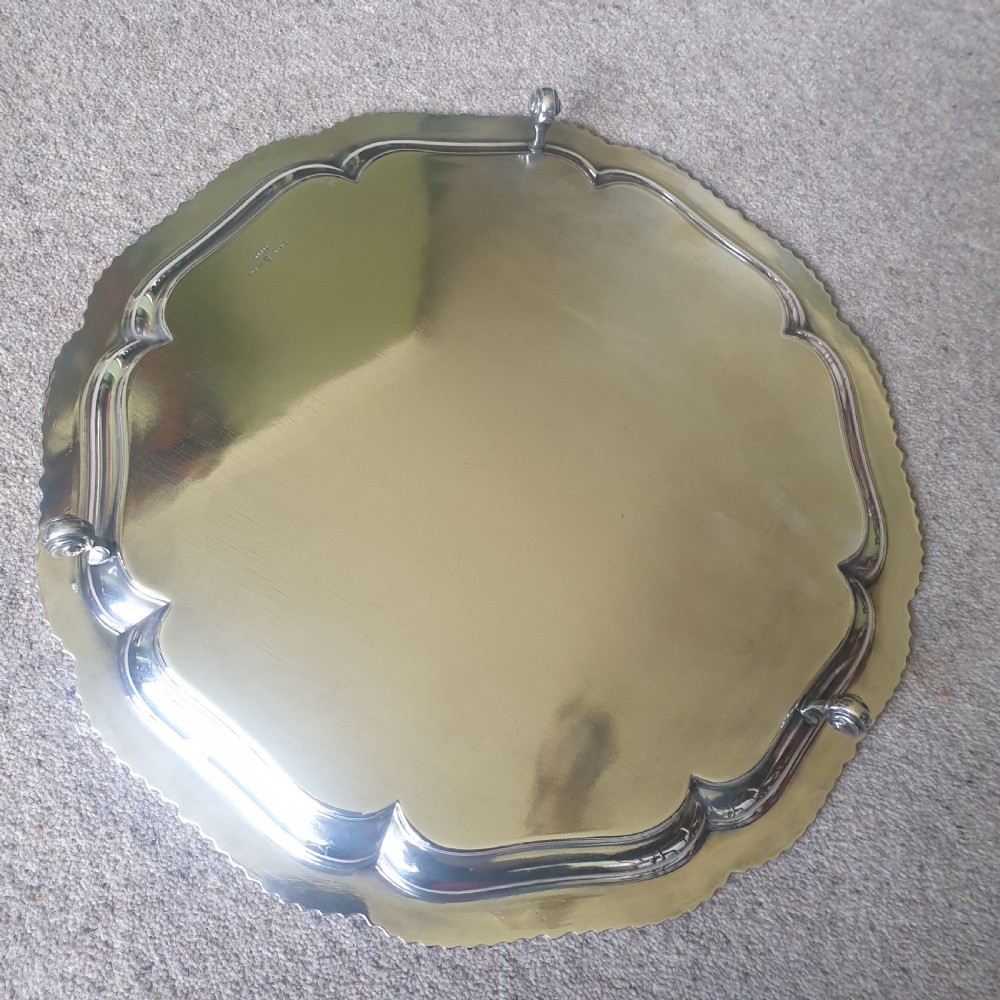 A circular silver-plated salver featuring a shaped, contoured border with gadrooned edge detailing. View II