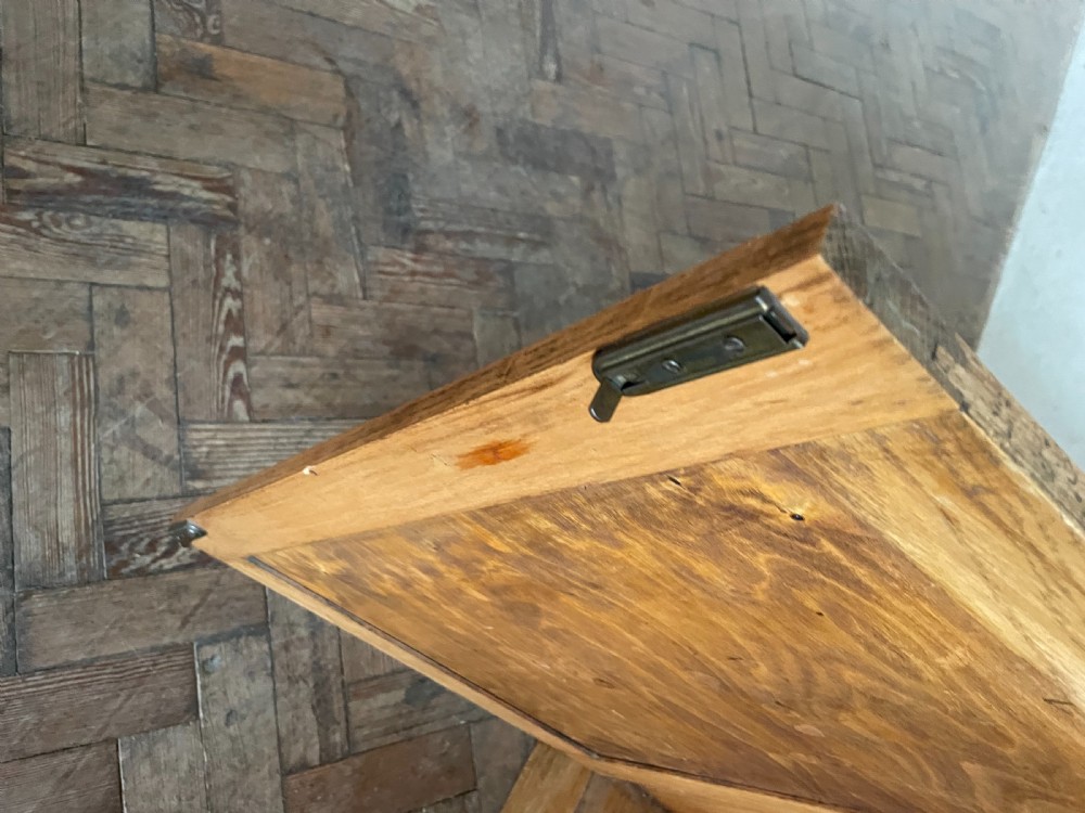 An Art Deco oak cabinet featuring two upper leaded glass doors over two solid wood panel doors with a stepped top crest. View IX
