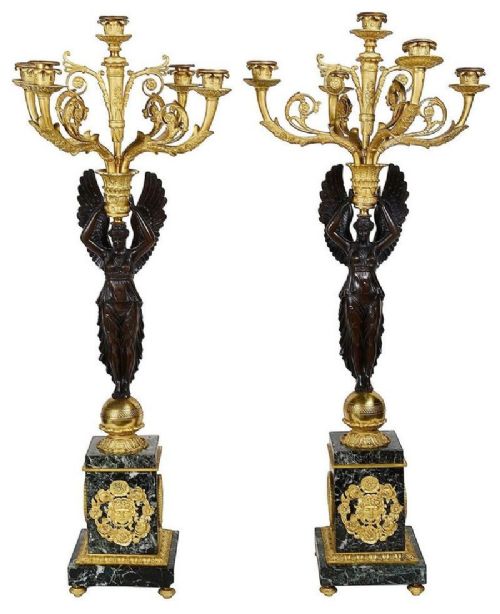 fig 1. A nineteenth-century French Empire style clock garniture comprising a central bronze and marble mantel clock flanked by two matching multi-light candelabra.