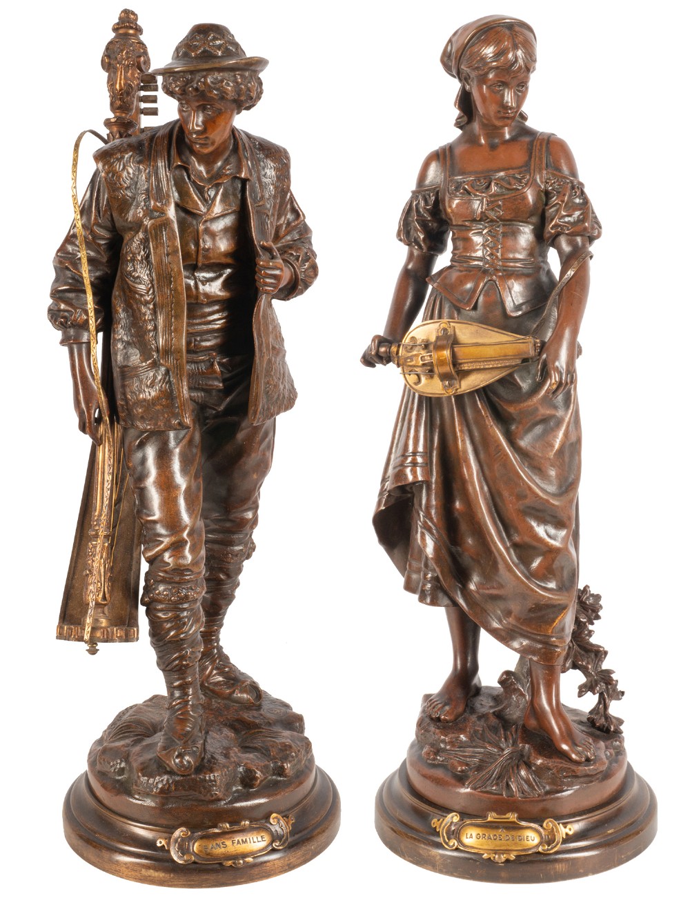 A pair of 19th-century dark patinated bronze statues of male and female folk musicians with gilt details on round stepped bases with title plaques.
