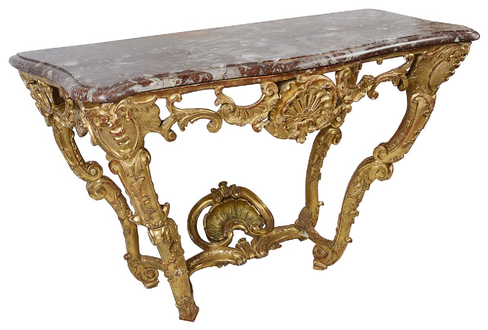 An 18th-century French Rococo console table featuring a carved giltwood frame with scroll motifs and a contoured red and grey veined marble top.
