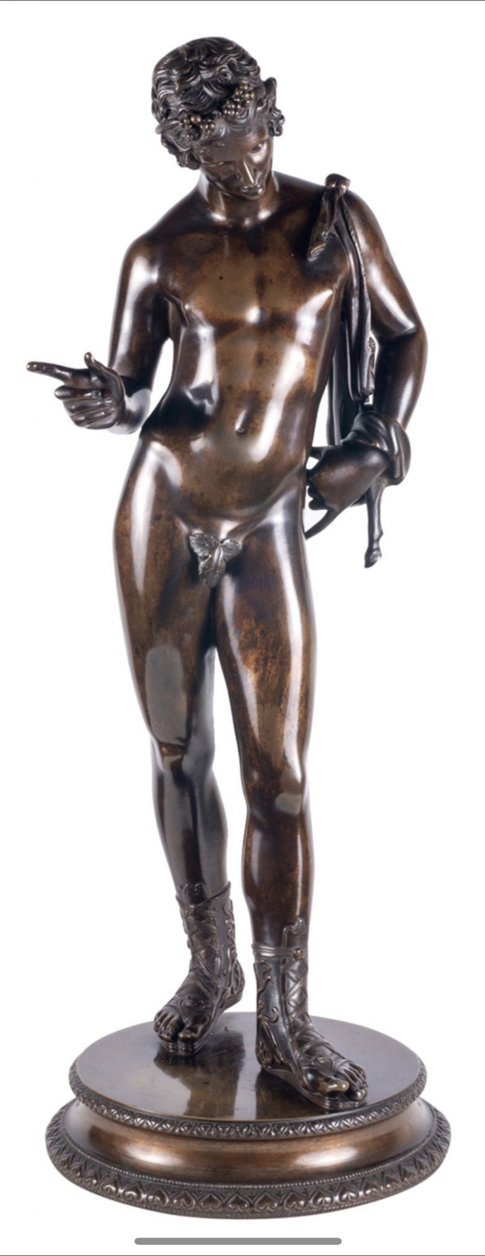 A 19th-century dark patinated bronze statue of Narcissus standing nude on a circular decorative base.