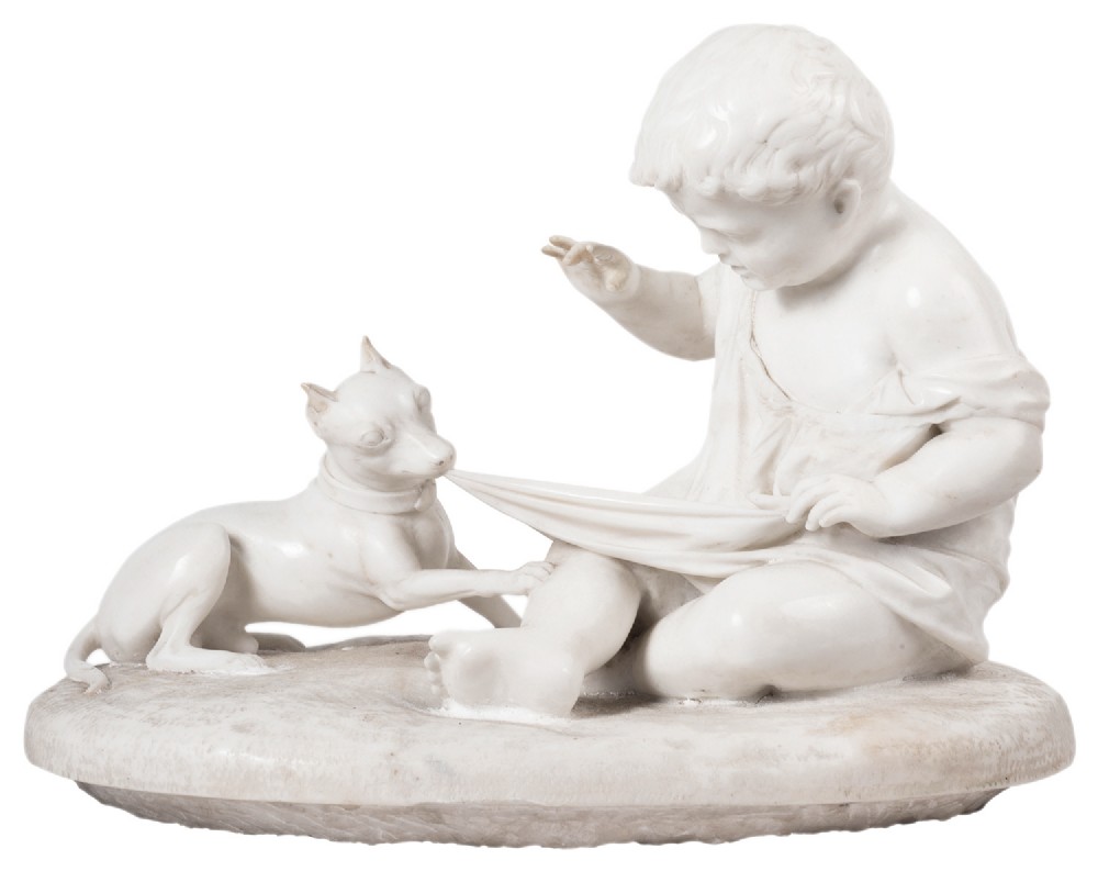 A carved white marble sculpture depicting a seated child interacting with a small puppy on an oval base.