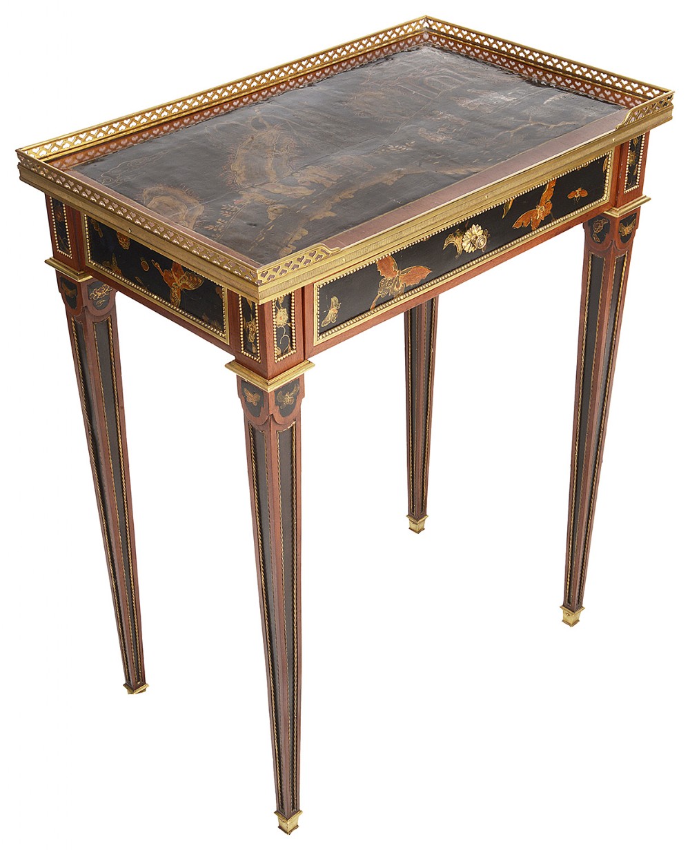 A rectangular 19th-century occasional table featuring black lacquer panels with gilded butterfly decorations, tapered legs, and a pierced brass gallery top.