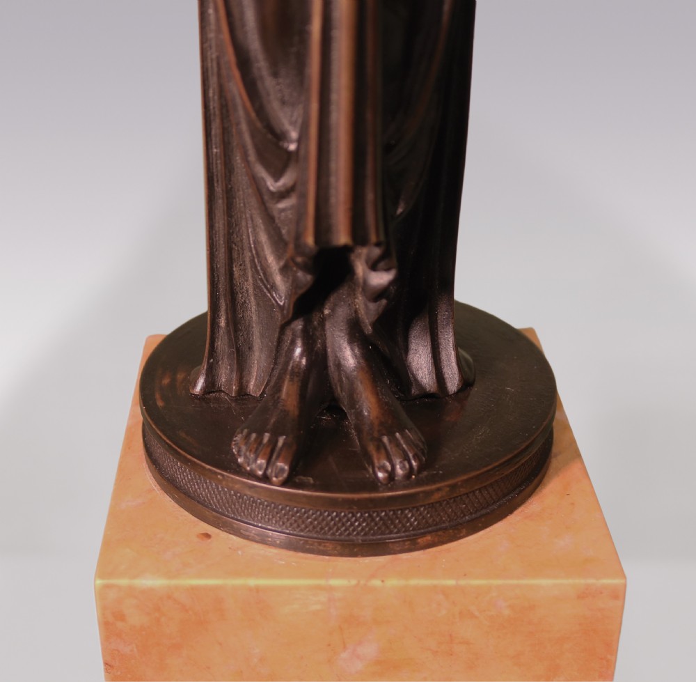 A pair of patinated bronze female caryatid candelabra holding two sconces each, mounted on tall rectangular yellow marble bases. View III