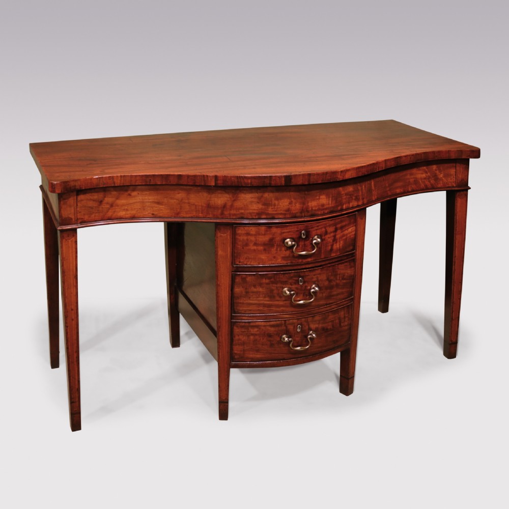 A George III period mahogany serving table featuring a curved front, central drawer stack with brass swan-neck handles, and tapered square legs. View II
