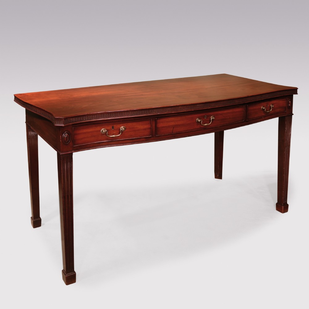 An 18th-century George III mahogany serving table featuring a serpentine front, three drawers with brass swan-neck handles, and fluted square tapered legs. View II