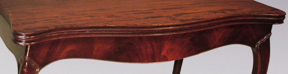 A late 18th-century Hepplewhite period mahogany card table featuring a serpentine-curved apron and cabriole legs. View IV