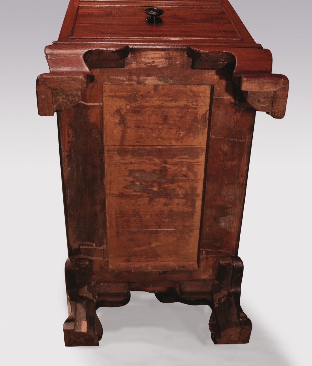 A compact George III mahogany pedestal desk featuring a dark leather writing inset surface, multiple small drawers with turned knobs, and shaped feet. View VI