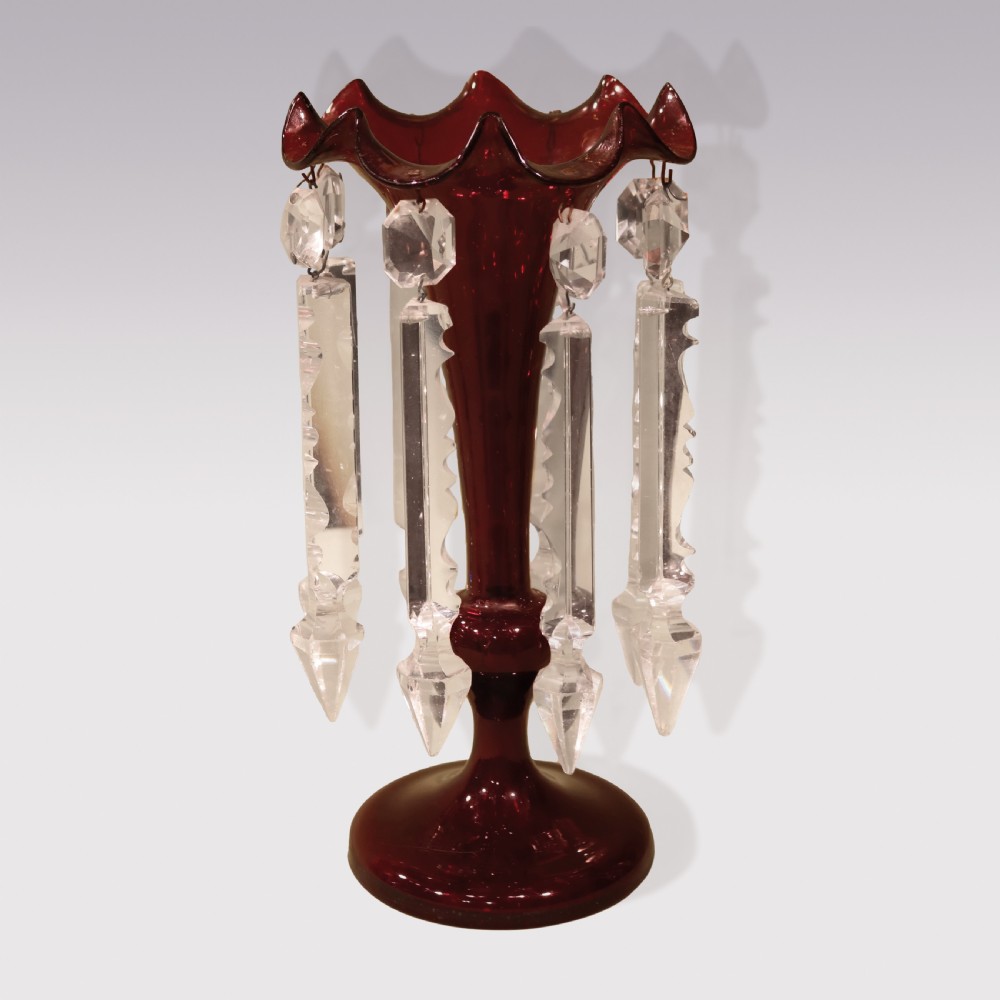 A pair of mid-19th century deep red cranberry glass mantle lustres with frilled rims and hanging clear cut-crystal prisms on circular bases. View III