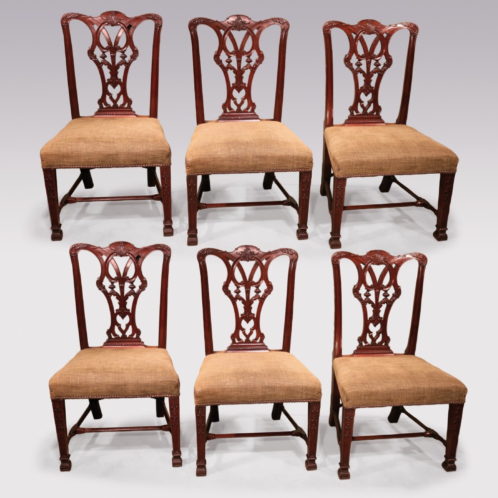 A set of six 19th-century Chippendale style mahogany single dining chairs featuring intricate pierced splats and textured woven seats.