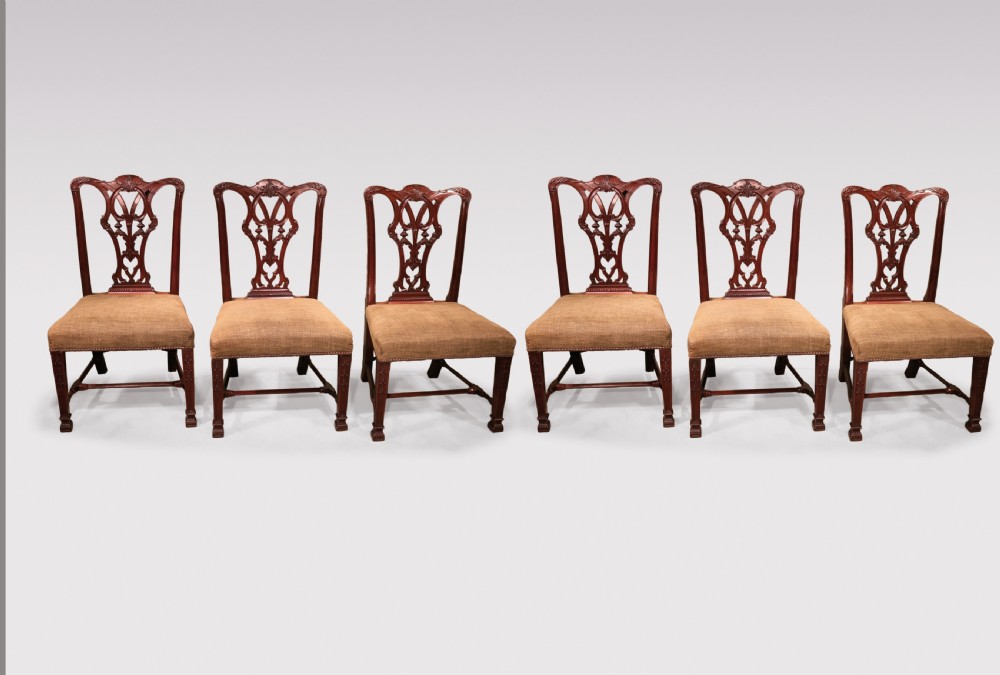 A set of six 19th-century Chippendale style mahogany single dining chairs featuring intricate pierced splats and textured woven seats. View II