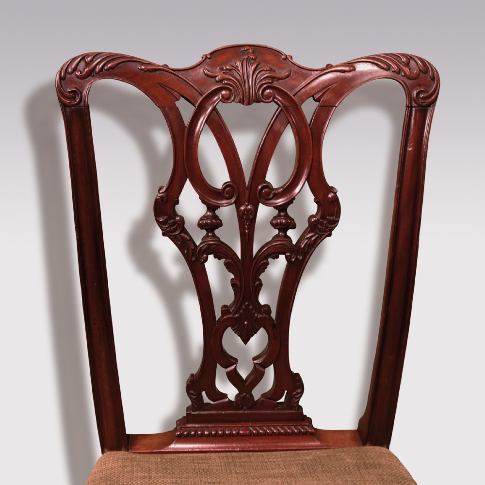 A set of six 19th-century Chippendale style mahogany single dining chairs featuring intricate pierced splats and textured woven seats. View VI