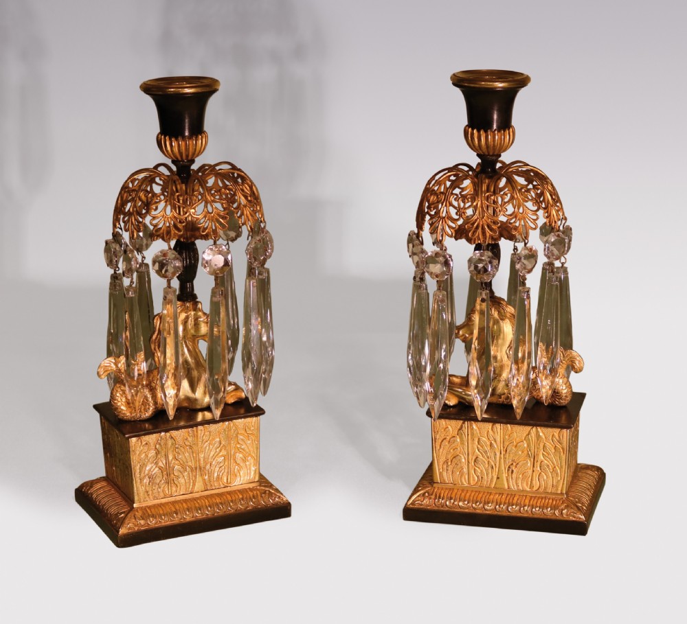 A set of three early 19th-century gilt bronze and patinated metal candlesticks featuring mythical seahorse mounts and hanging cut crystal drops. View III