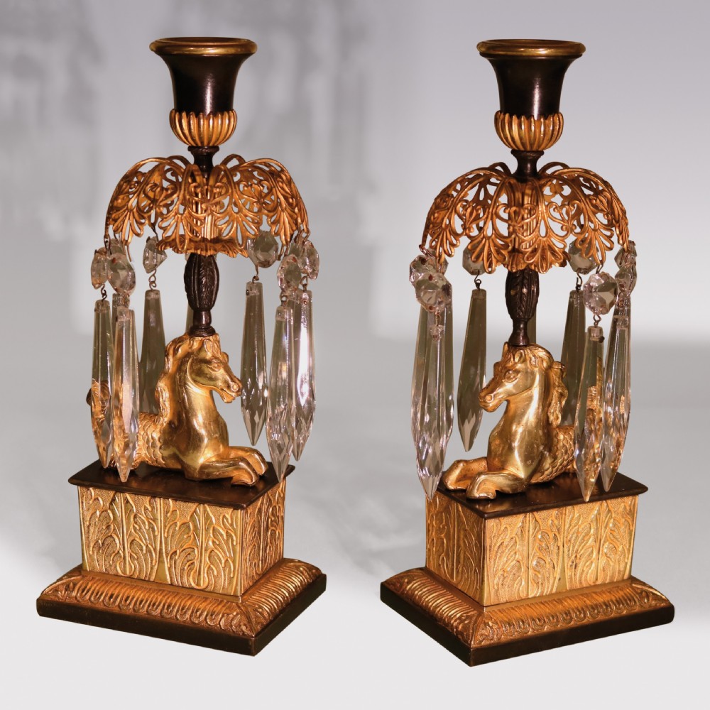 A set of three early 19th-century gilt bronze and patinated metal candlesticks featuring mythical seahorse mounts and hanging cut crystal drops. View IV