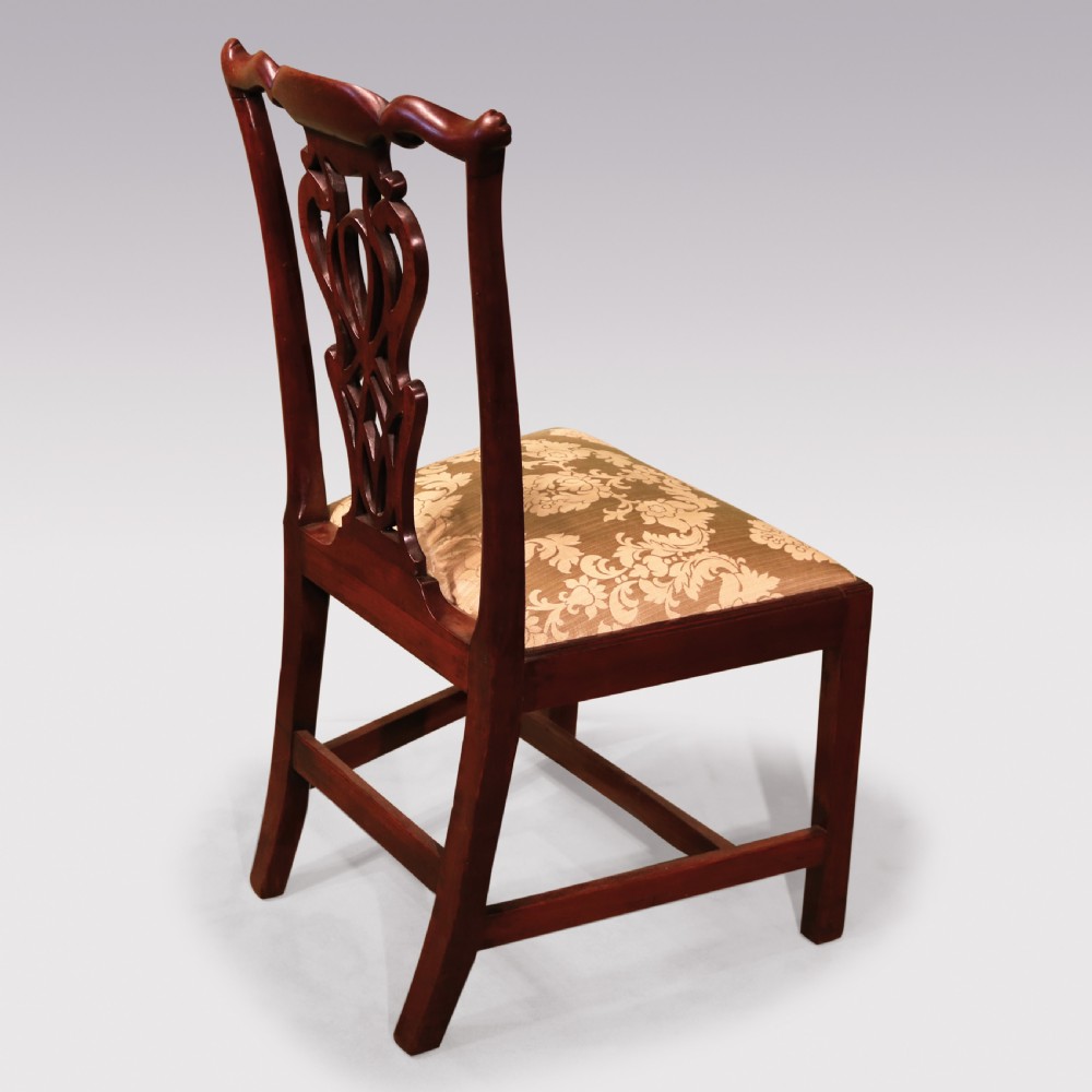 A pair of Georgian Chippendale carved mahogany single dining chairs featuring detailed pierced splats and patterned fabric upholstered seats. View III
