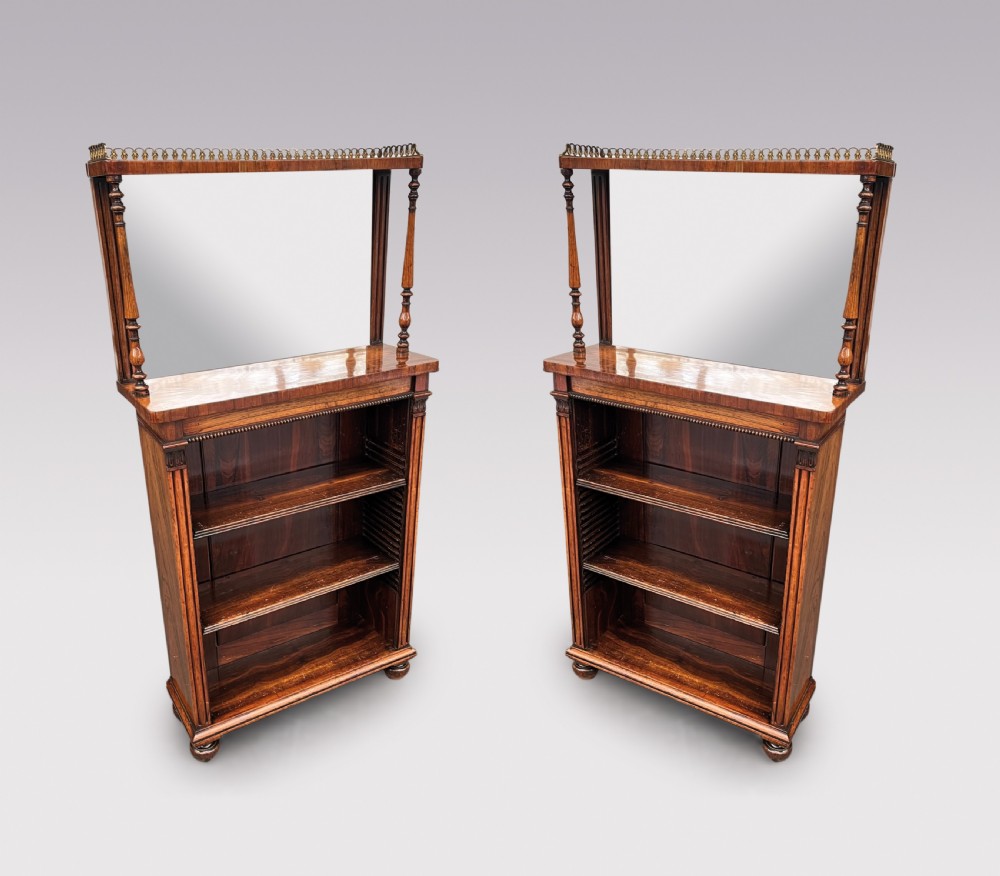 A pair of Regency period rosewood open bookcases featuring upper mirrored backs with brass gallery tops and turned support columns above open adjustable shelves. View II