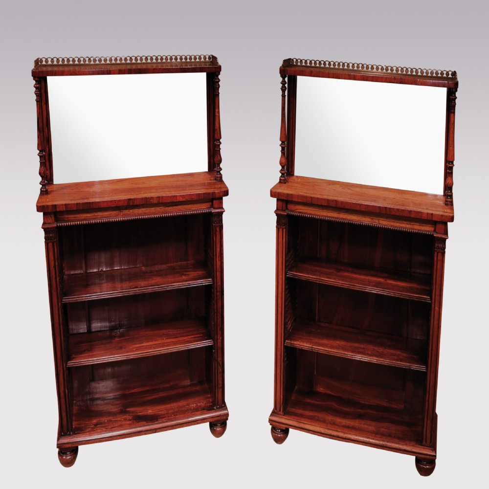 A pair of Regency period rosewood open bookcases featuring upper mirrored backs with brass gallery tops and turned support columns above open adjustable shelves. View III