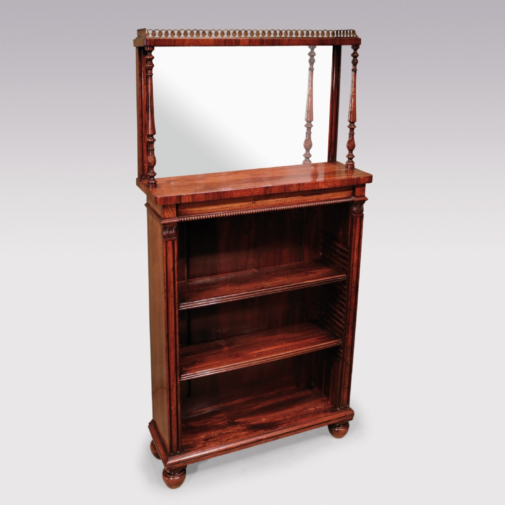A pair of Regency period rosewood open bookcases featuring upper mirrored backs with brass gallery tops and turned support columns above open adjustable shelves. View IV