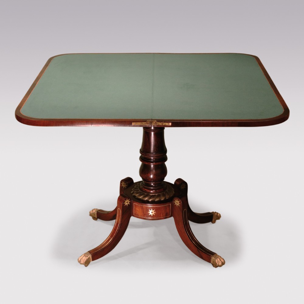 A pair of Regency period rosewood card tables featuring brass inlaid tops, turned central pedestals, and four splayed legs with brass paw feet. View III