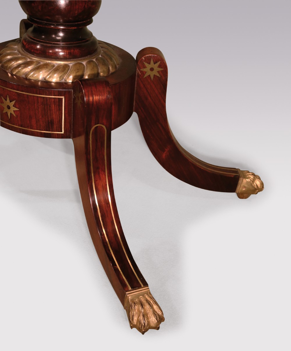 A pair of Regency period rosewood card tables featuring brass inlaid tops, turned central pedestals, and four splayed legs with brass paw feet. View VII